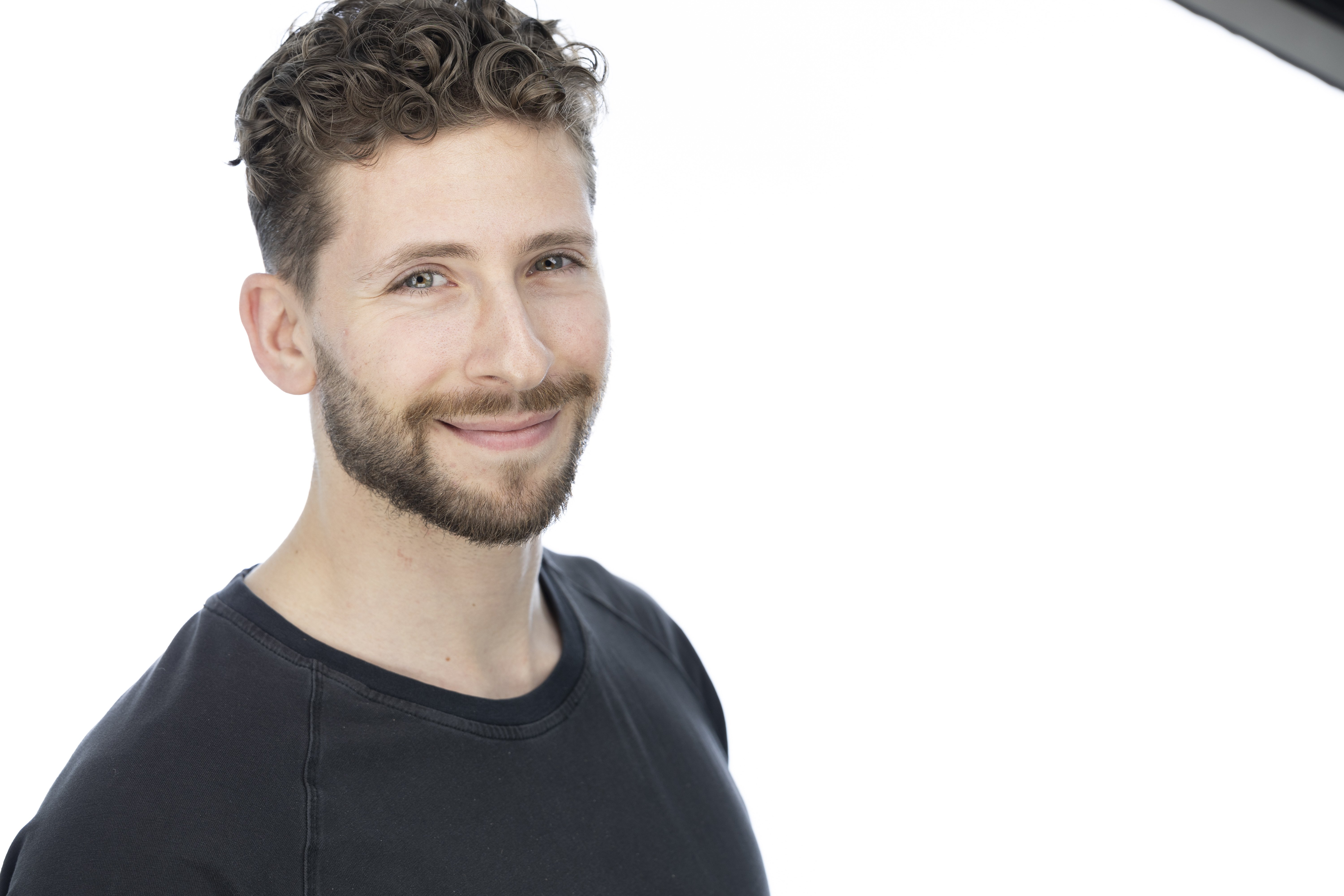 Matt Fishman smiling in a studio portrait